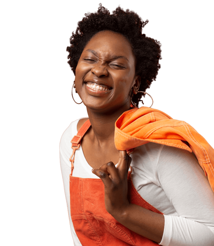 A girl smiling with a coat over a shoulder